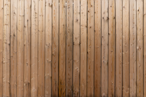 wooden wall with vertical planks, natural texture and grain patterns showcasing rustic charm